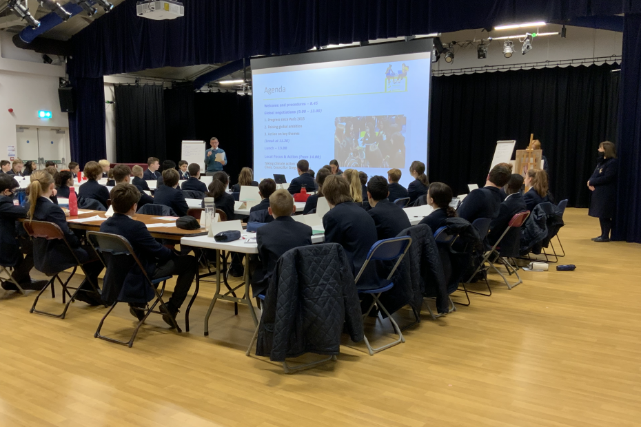 students sitting at tables looking at screen